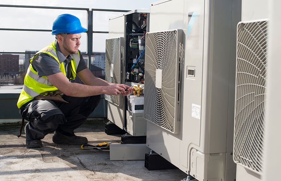 Commercial HVAC Technician fixing unit