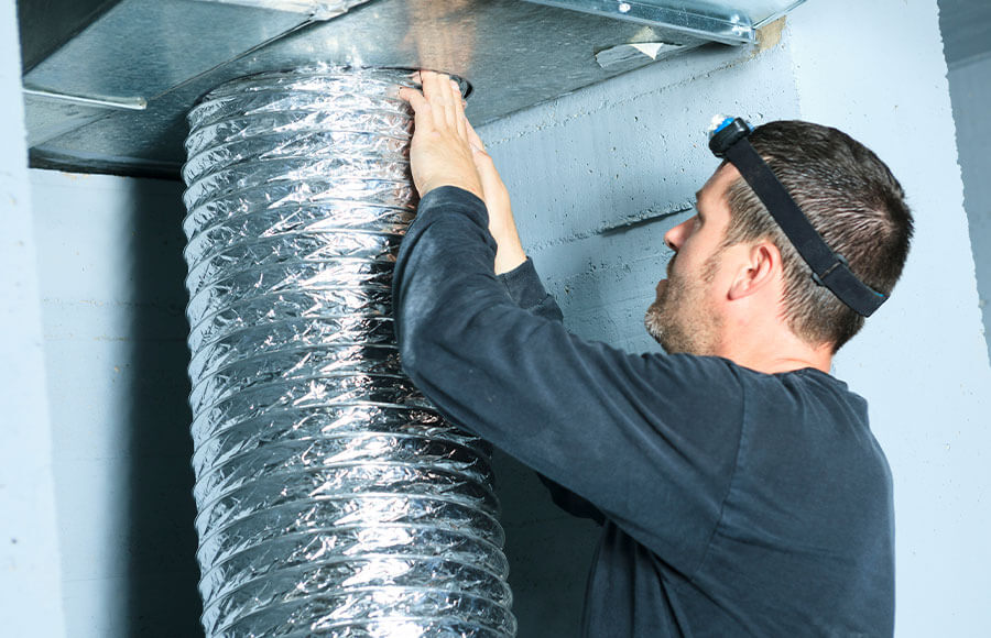 Technician Cleaning air duct in home